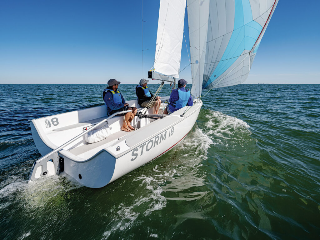 Mike Ingham, on the helm, Erik Shampain on the jib trim and Dave Reed, to port
