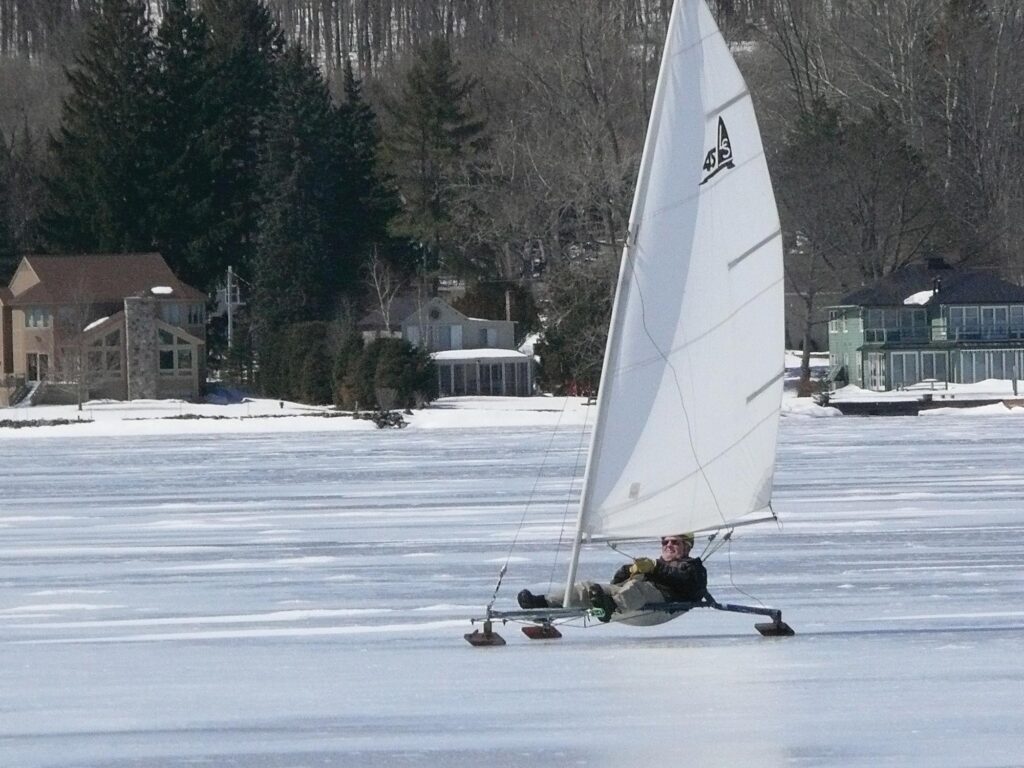 Man iceboating on a Locksley Skimmer class iceboat