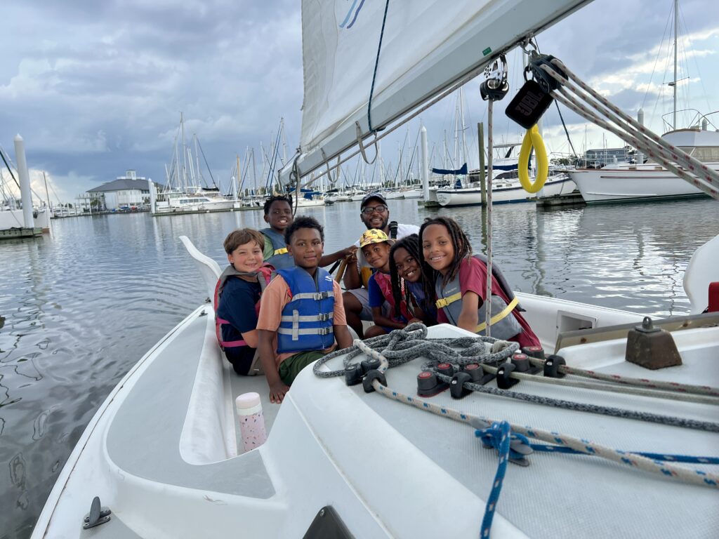 Kids from the New Orleans Community Sailing Center on a sailboat at the dock.