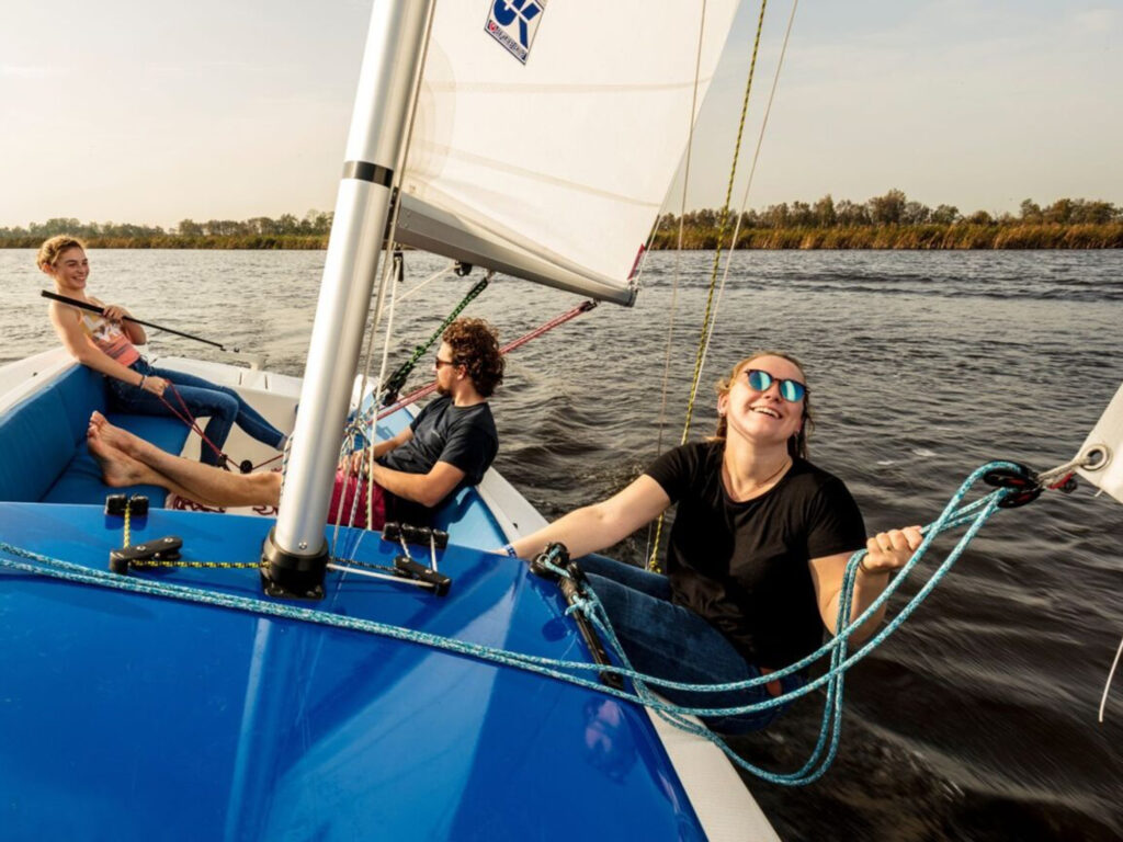 3 people on a sailboat