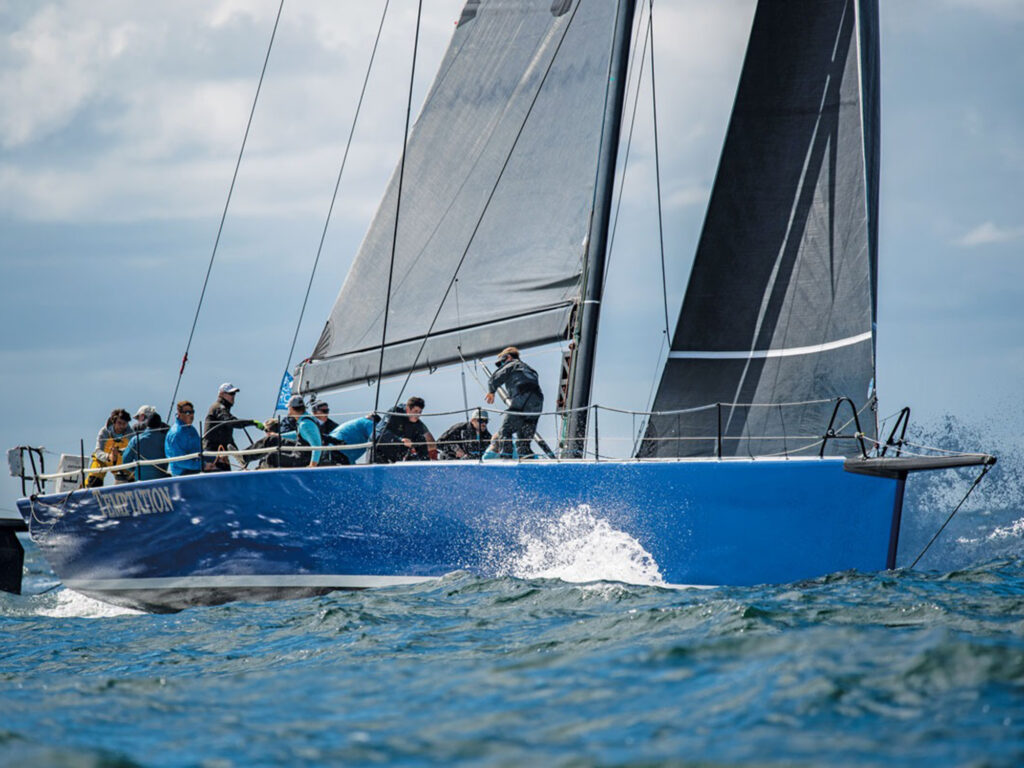high-tech raceboat with active crew sailing through splashing water at the ORC World Championships in Newport Rhode Island